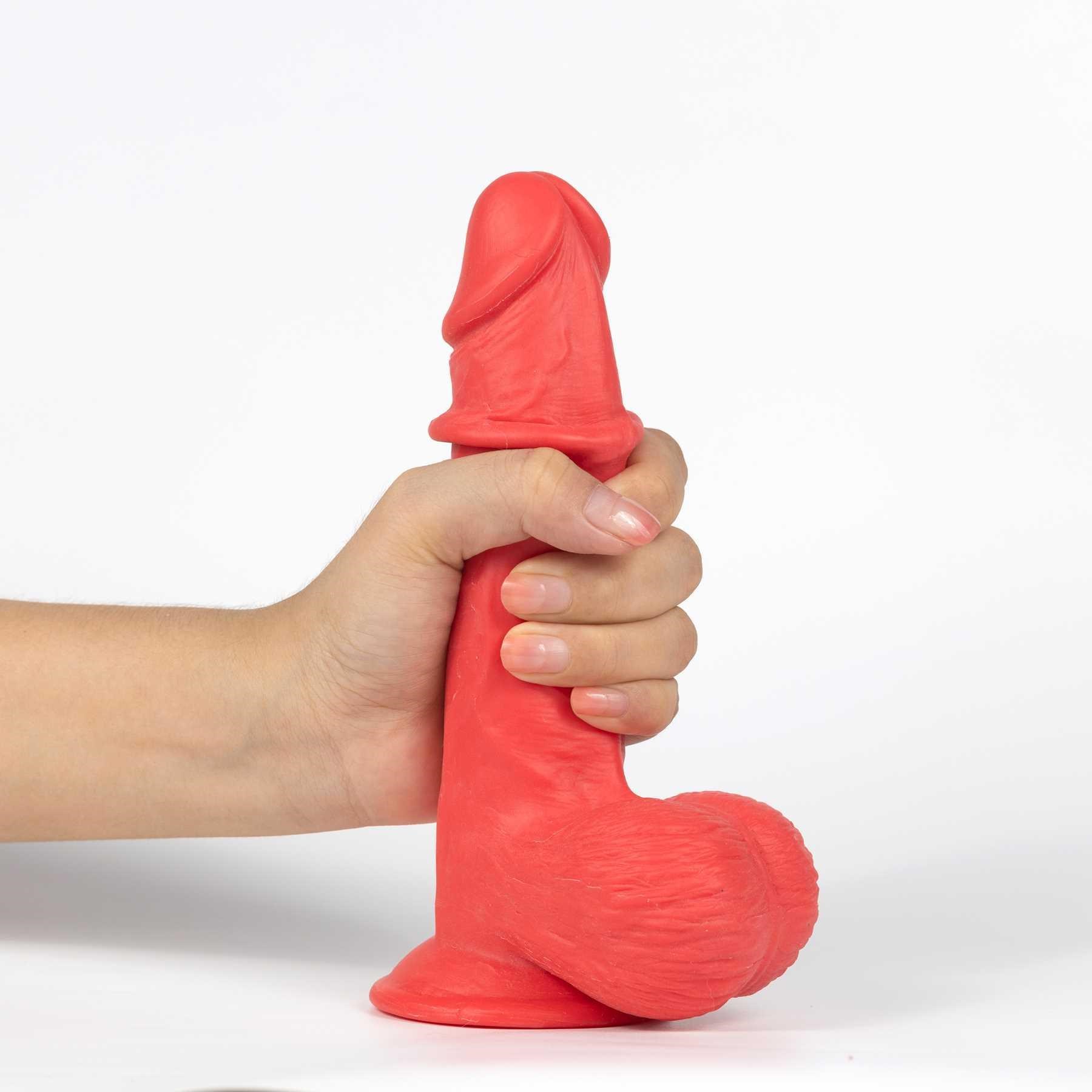 Get Lucky Mr. Ruby 7.5 Dual Layer Dildo hand gripping and skin on shaft rolled up