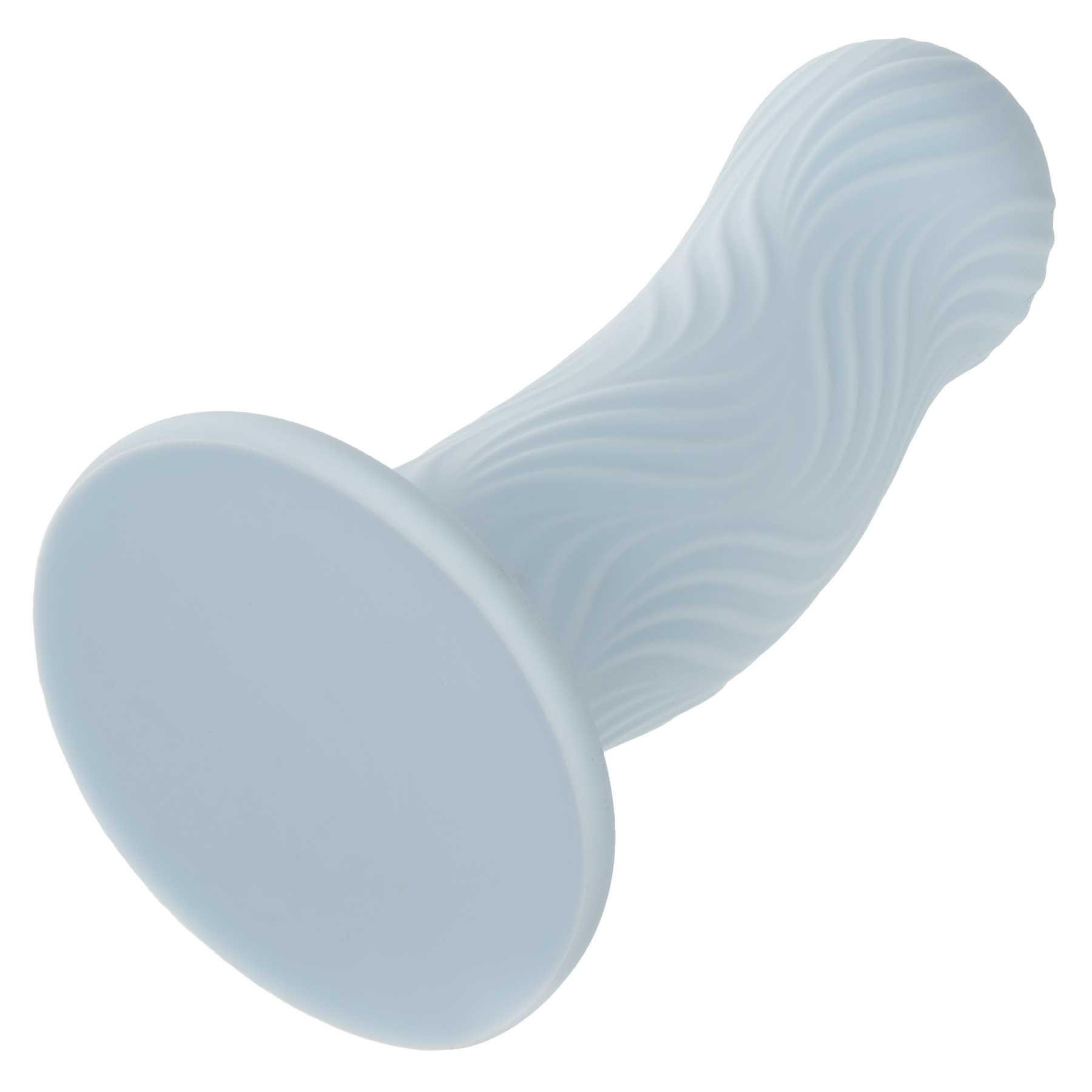 Wave Rider Foam Liquid Silicone Dildo laying on table suction cup end forward