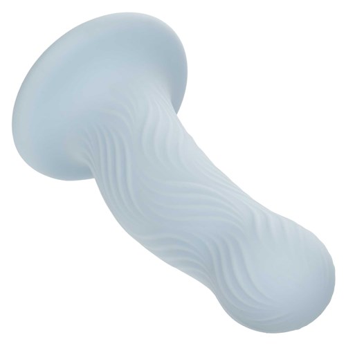 Wave Rider Foam Liquid Silicone Dildo laying on table tip end forward