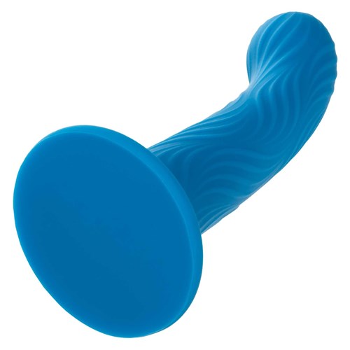 Wave Rider Ripple Liquid Silicone Dildo laying on table suction cup end forward