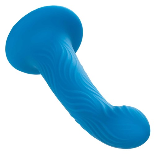 Wave Rider Ripple Liquid Silicone Dildo laying on table tip end forward